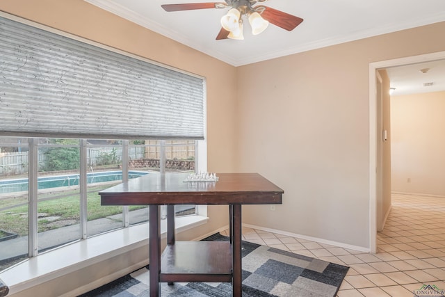 tiled dining area featuring ceiling fan and crown molding