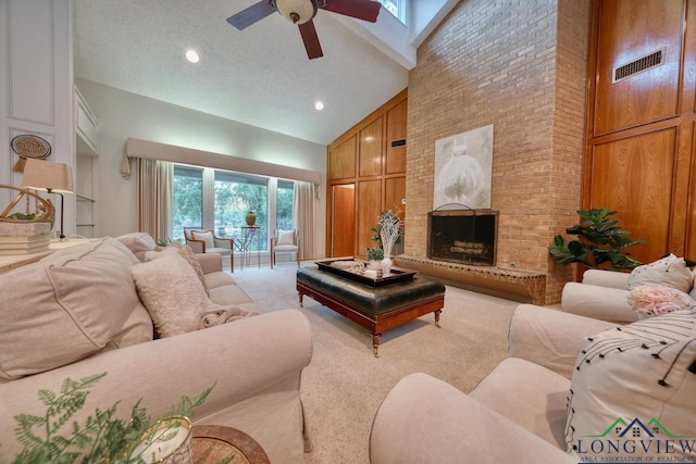 living room featuring ceiling fan, high vaulted ceiling, carpet floors, a brick fireplace, and wood walls