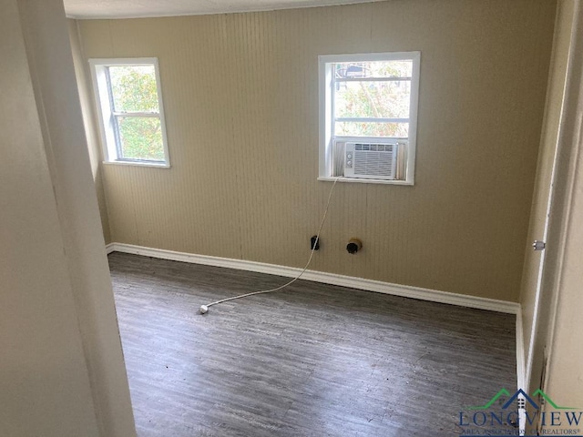 spare room with cooling unit and dark hardwood / wood-style floors