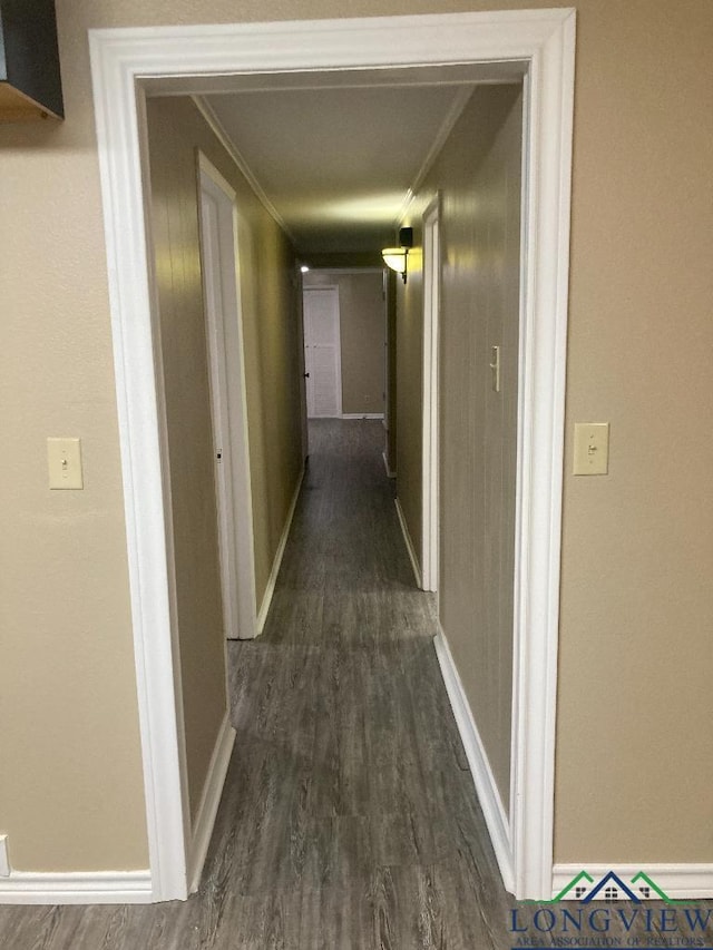 hallway featuring ornamental molding and dark hardwood / wood-style floors