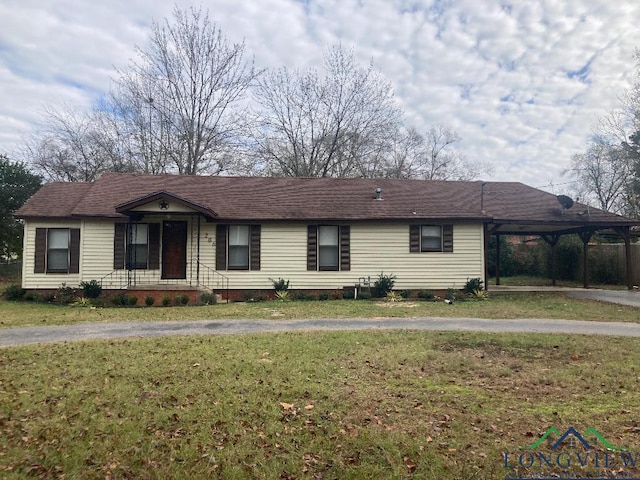 ranch-style home with a carport and a front lawn