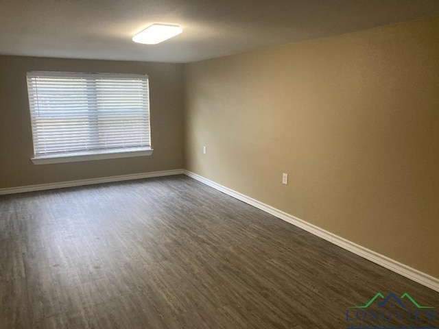 unfurnished room with dark hardwood / wood-style floors