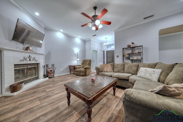 846 Edgewood Cir, Lindale, TX 75771 - living room with a ceiling fan, wood finished floors, crown molding, a brick fireplace, and recessed lighting