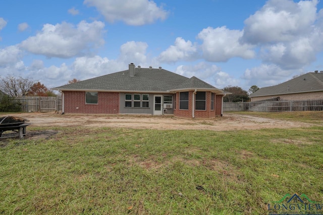 846 Edgewood Cir, Lindale, TX 75771 - rear view of house with a fire pit, a chimney, and brick siding