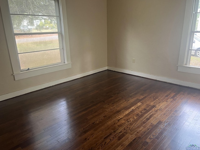 unfurnished room featuring dark wood-type flooring