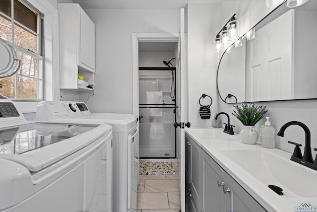 washroom featuring sink and independent washer and dryer