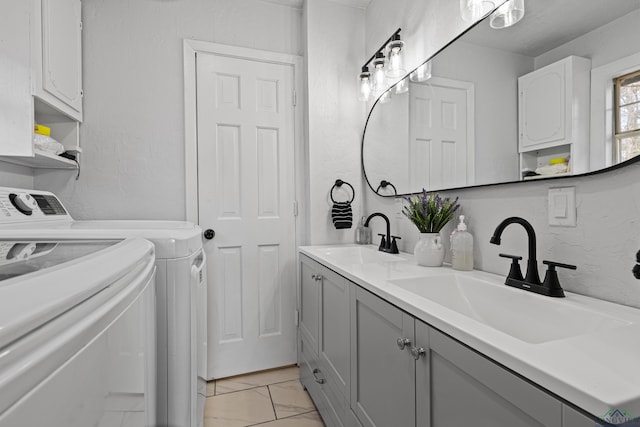 laundry area with washing machine and clothes dryer and sink