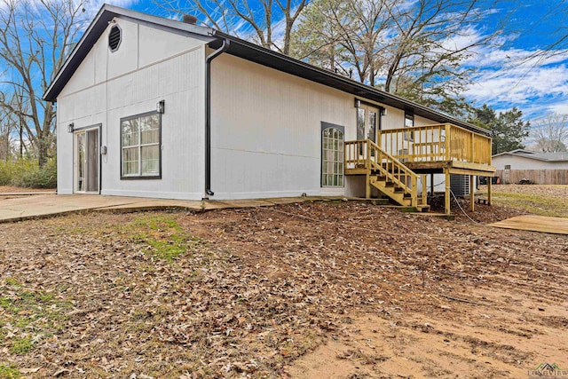 view of property exterior featuring a patio area and a deck