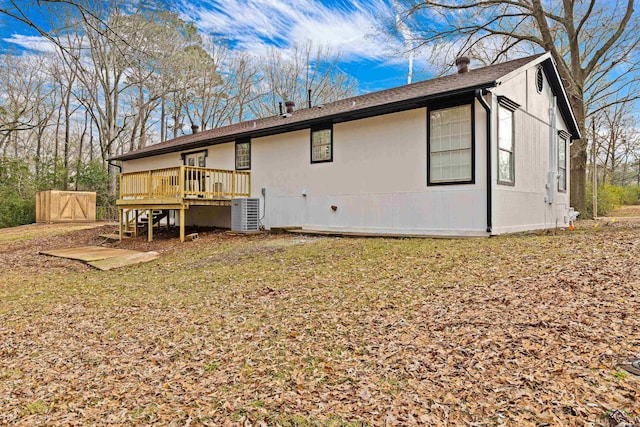 back of house featuring a wooden deck and central AC