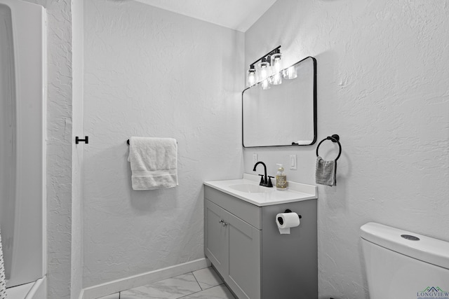 bathroom featuring vanity and toilet