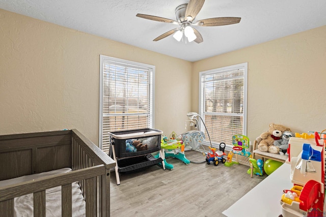 bedroom with ceiling fan and light hardwood / wood-style flooring