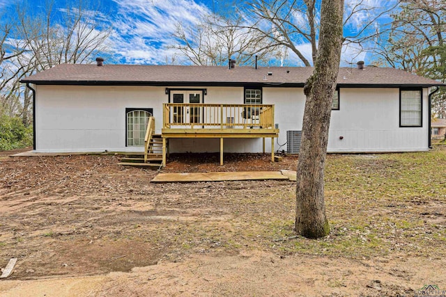 back of property with a deck and french doors