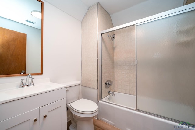 bathroom with enclosed tub / shower combo, visible vents, vanity, and toilet