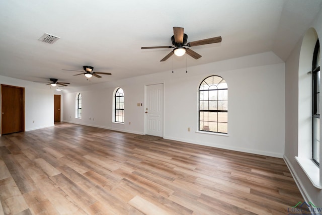 unfurnished living room with light wood-style floors, visible vents, and baseboards