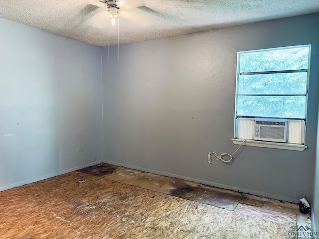 spare room with a textured ceiling, cooling unit, and ceiling fan