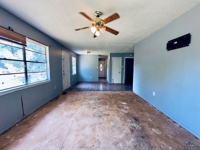 unfurnished room featuring ceiling fan and a textured ceiling