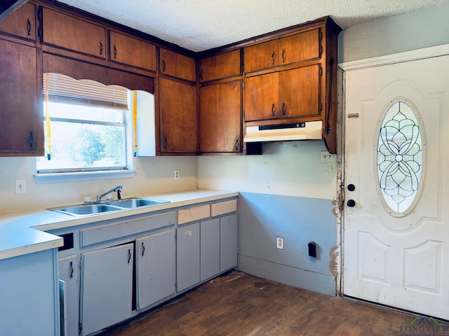 kitchen with a textured ceiling, dark hardwood / wood-style floors, and sink