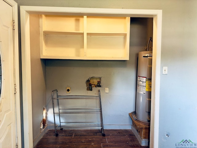 laundry area with dark hardwood / wood-style flooring and water heater