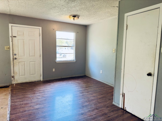 entryway featuring dark hardwood / wood-style floors and a textured ceiling