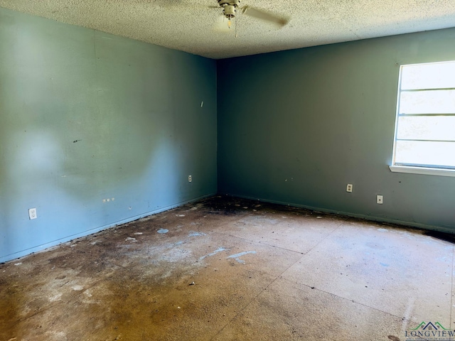 spare room featuring ceiling fan and a textured ceiling