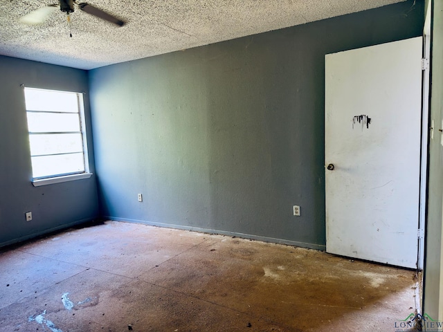 empty room featuring ceiling fan and a textured ceiling