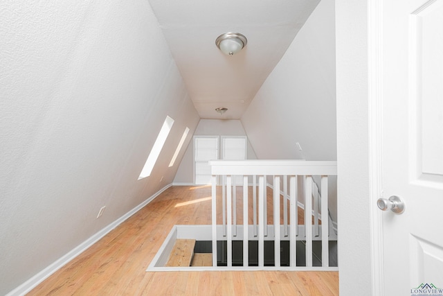 interior space featuring vaulted ceiling and wood finished floors