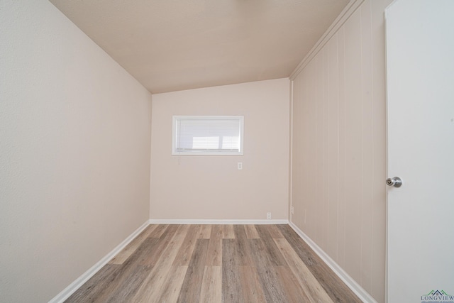 spare room featuring light wood-style flooring and baseboards