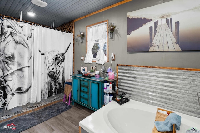 bathroom with wood-type flooring, curtained shower, and vanity