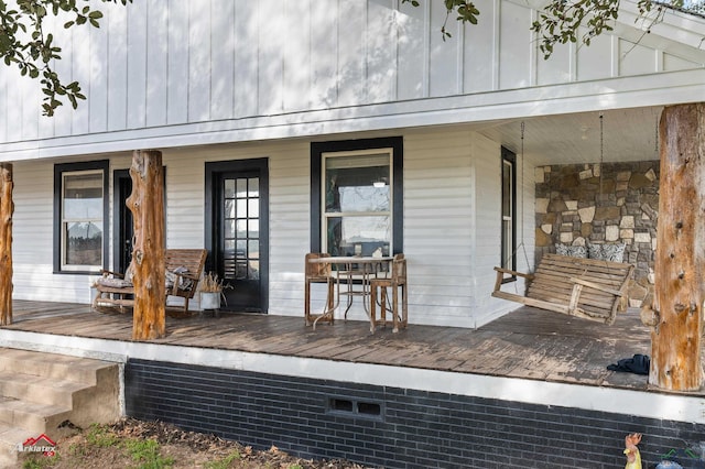 view of exterior entry with covered porch