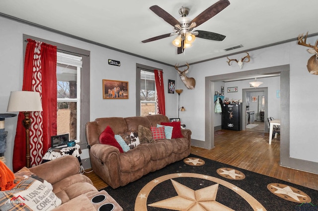 living room with ceiling fan, ornamental molding, and hardwood / wood-style floors