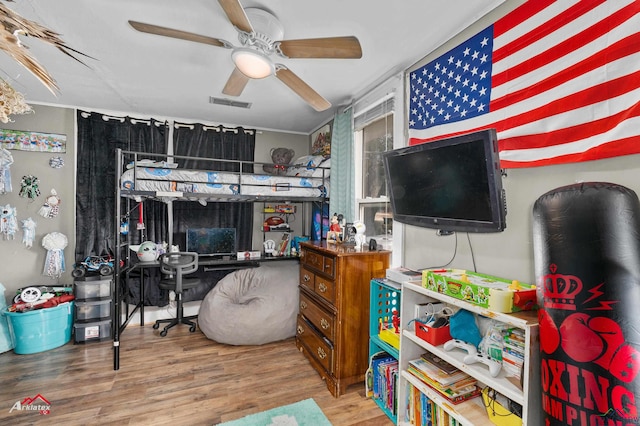 bedroom featuring hardwood / wood-style floors and ceiling fan