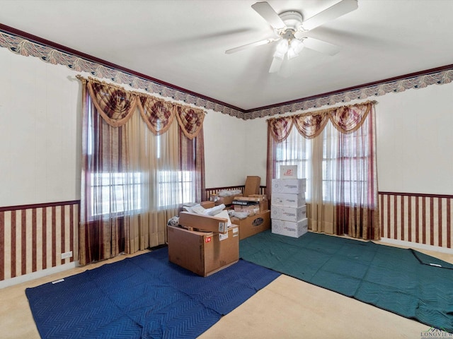 office with wallpapered walls, carpet, crown molding, and a ceiling fan