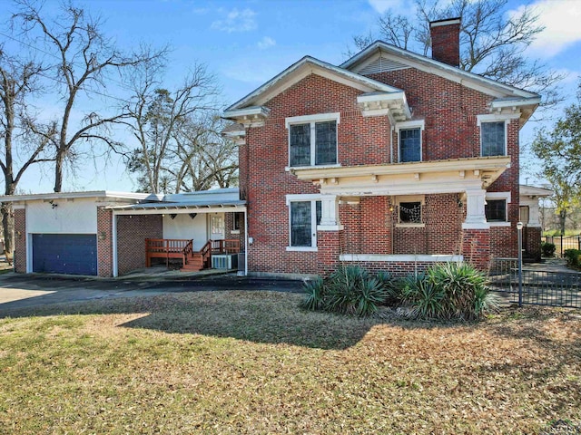 view of front of home featuring brick siding, a chimney, a porch, a garage, and a front lawn