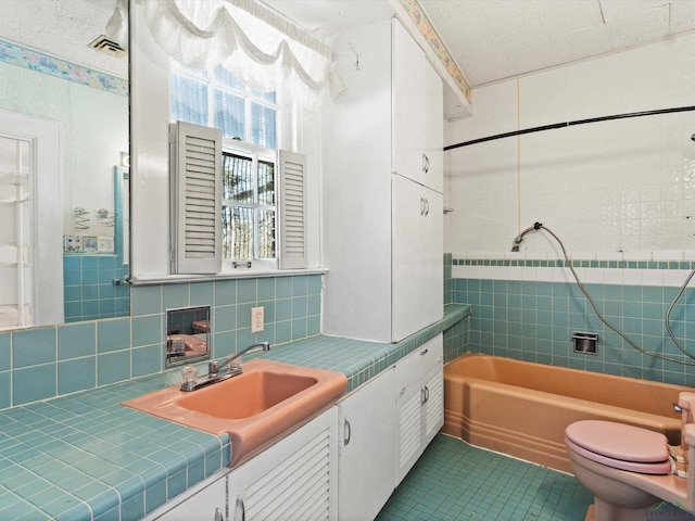 bathroom with tasteful backsplash, visible vents, toilet, tile patterned flooring, and vanity