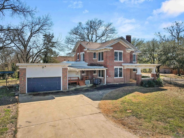 view of front facade with driveway, a chimney, fence, and brick siding