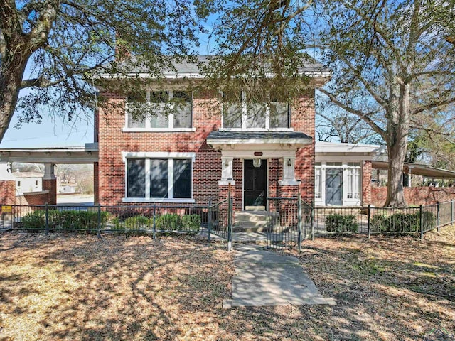 view of front of property with a fenced front yard and brick siding