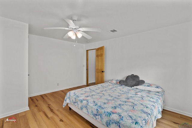 bedroom with ceiling fan and light hardwood / wood-style floors