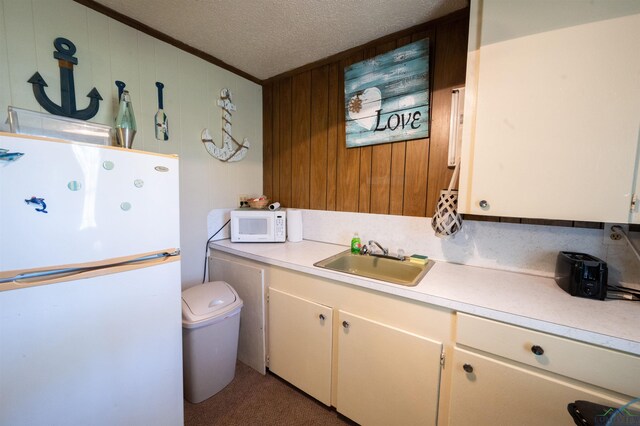 8880 Fm 729, Avinger, TX 75630 - laundry area with crown molding, a textured ceiling, a sink, and wooden walls