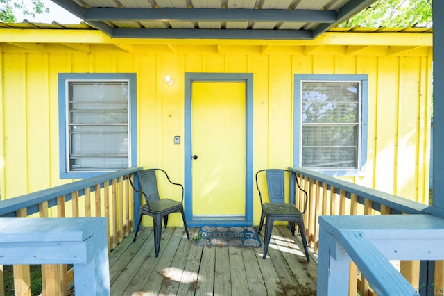 8880 Fm 729, Avinger, TX 75630 - doorway to property with a wooden deck and board and batten siding
