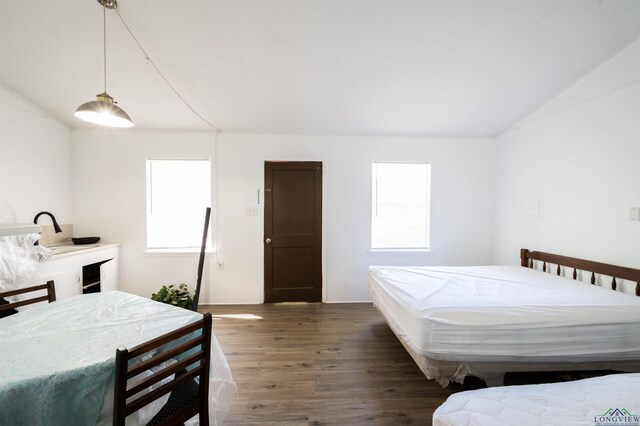 8880 Fm 729, Avinger, TX 75630 - bedroom with lofted ceiling and wood finished floors