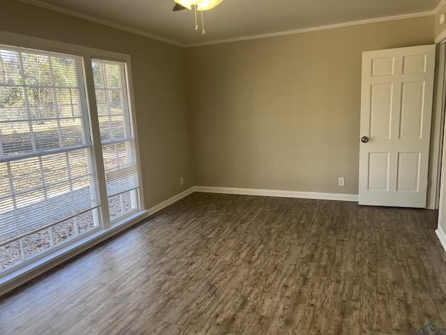 spare room featuring dark hardwood / wood-style flooring, ornamental molding, and ceiling fan