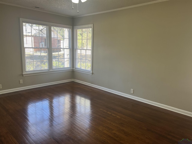 spare room with ornamental molding, dark wood-type flooring, and a textured ceiling