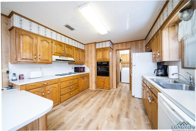 kitchen featuring white appliances, a textured ceiling, sink, light hardwood / wood-style flooring, and ornamental molding