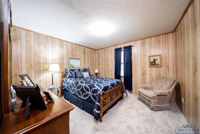 bedroom with a textured ceiling and carpet flooring