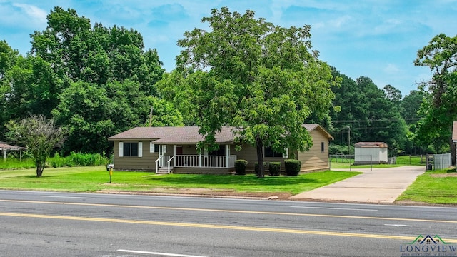 ranch-style home with covered porch and a front lawn