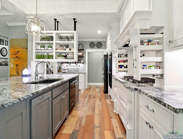 kitchen featuring white cabinetry, open shelves, a sink, light wood finished floors, and gray cabinets
