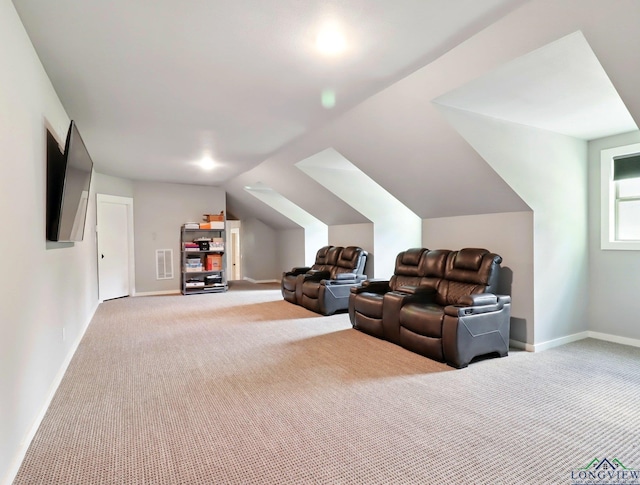 interior space featuring lofted ceiling, visible vents, light colored carpet, and baseboards