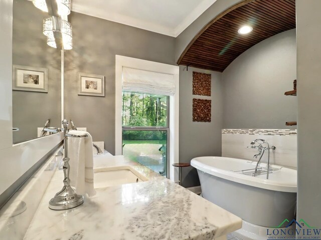 bathroom with a freestanding tub and vanity