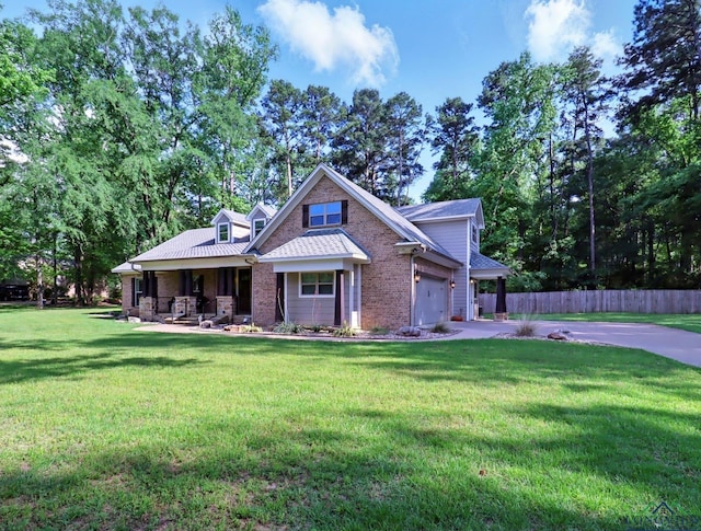 craftsman inspired home with covered porch, brick siding, fence, a front lawn, and concrete driveway
