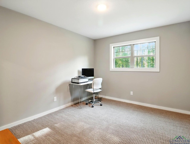 carpeted office space featuring baseboards